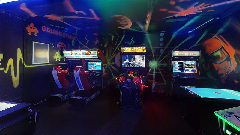 The neon arcade room with games machines and a dance mat